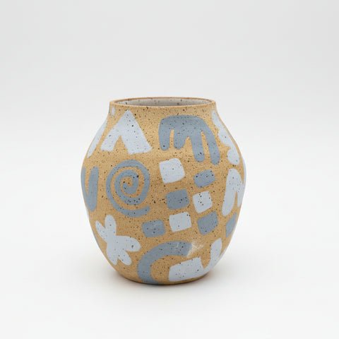 Ceramic vase with abstract patterns on a wooden surface