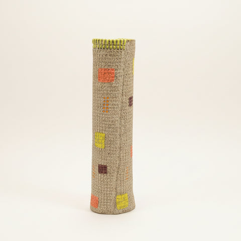 Textured cylindrical vase with hand sewn details.