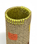 Cylindrical ceramic vase with textured surface and colorful accents.