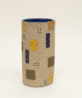 Textured cylindrical vase with hand sewn details.