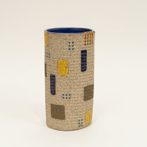 Textured cylindrical vase with hand sewn details.