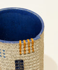 Ceramic vase with blue interior and textured exterior