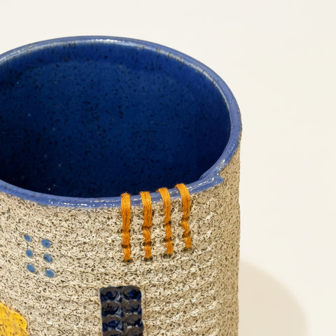 Ceramic vase with blue interior and textured exterior