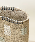 Close-up of a textured ceramic vase with speckled pattern.