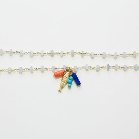 necklace with charms on a wooden surface