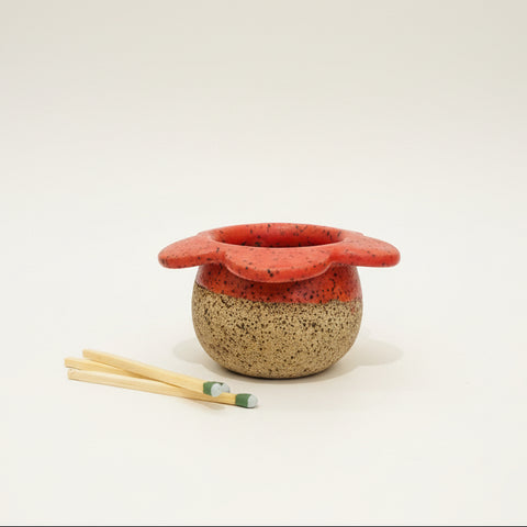 Red flower-shaped match holder