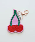 Cherry-shaped keychain with pink background