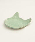 Ceramic shark fin dish on a wooden surface