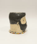Ceramic mug with a unique design on a wooden surface