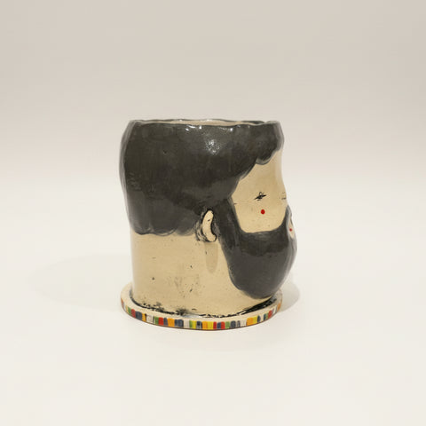 Ceramic mug with a unique design on a wooden surface