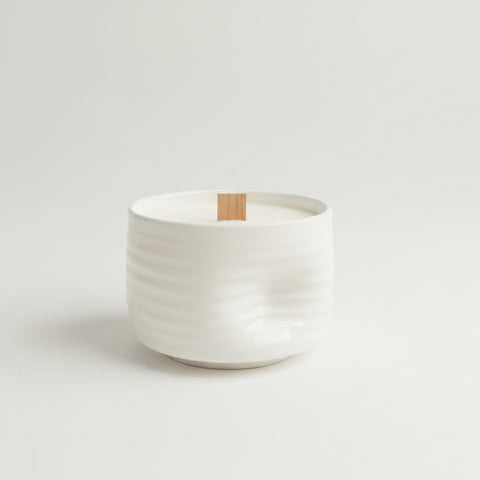 White ceramic container on a wooden surface with a blurred background