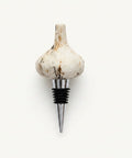 Garlic-shaped bottle stopper on a wooden surface