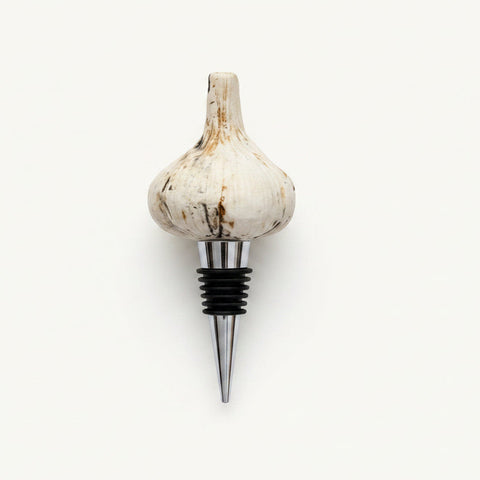 Garlic-shaped bottle stopper on a wooden surface