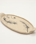 Decorative ceramic plate with artistic design on a wooden surface