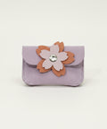 Small purple pouch with a floral design on a wooden surface
