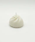 White candle on a white background
