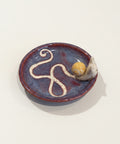 Ceramic dish with a decorative design on a wooden surface