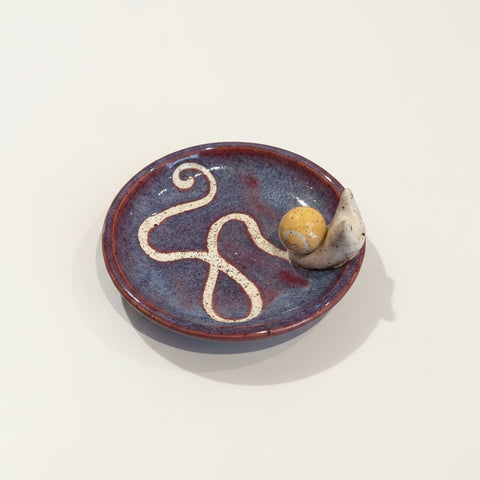 Ceramic dish with a decorative design on a wooden surface