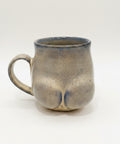 Ceramic mug with a unique design on a wooden surface