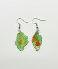 Pair of green earrings on a wooden surface