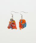 Colorful earrings on a wooden surface