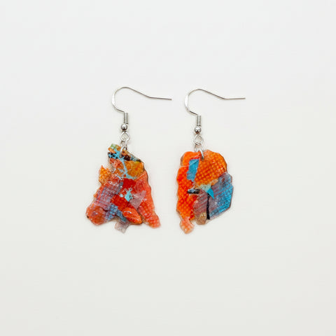 Colorful earrings on a wooden surface