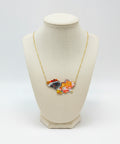Necklace with a colorful pendant on a wooden surface