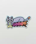 Sticker of a cat with a star and galaxy design on a wooden surface