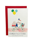 Congratulations card with stork and baby illustration on a wooden surface