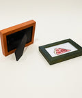 Two small picture frames on a wooden surface, one with a black background and the other with a pizza illustration.