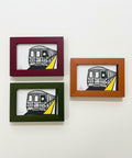 Three framed illustrations of a train on a wooden surface