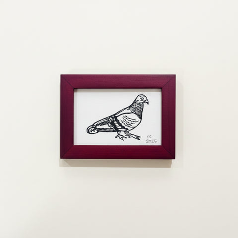 Framed illustration of a bird on a wooden surface