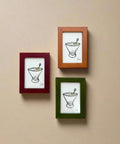 Three framed illustrations on a wooden wall.