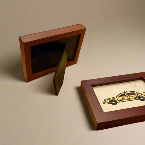 Wooden picture frames on a wooden table with a store interior in the background