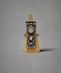 Sterling silver ring on a wooden surface with a blurred background