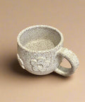 Speckled ceramic mug with floral motif