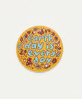 Round sticker with 'earth day is every day' text on a wooden surface