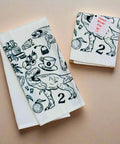 Two white towels with dark green illustrations