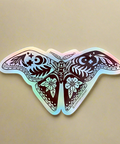 Holographic butterfly sticker on a tan surface