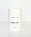 White candle jar labeled 'Charred Guava' by Sincerely Sunday on a white background