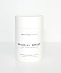 Candle jar labeled 'Brooklyn Sunset' by Sincerely Sunday on a white background