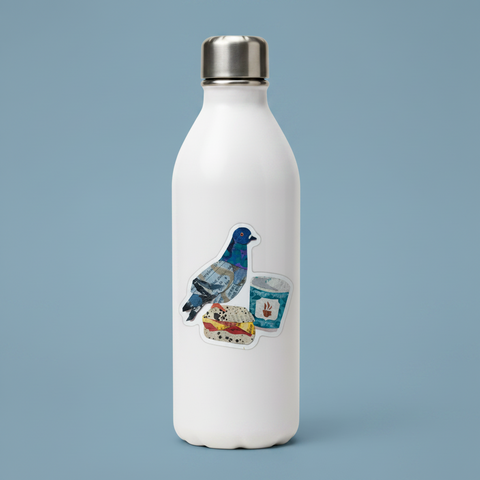 A die-cut sticker featuring a collage of a blue pigeon, a sandwich, and a coffee cup made from mixed paper textures, photographed on a light cream background.