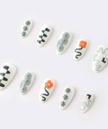 Set of white nail art designs on a white background