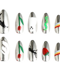 Set of nail art designs on metallic nail extensions against a white background