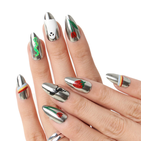 Hand with silver and green nail art on a white background