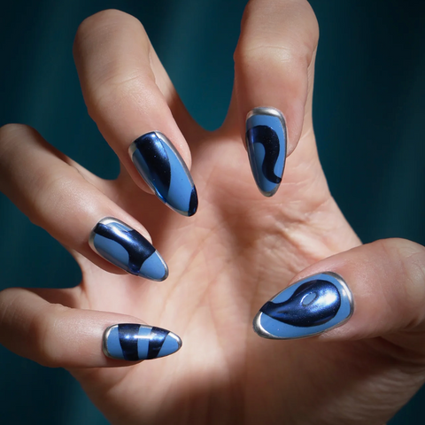 Hand with blue nail polish on a dark background
