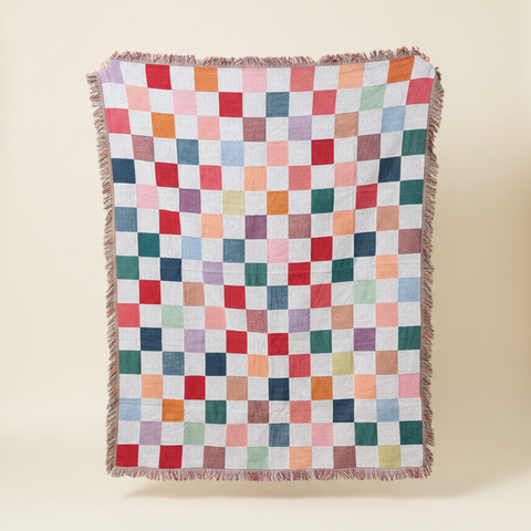 Multicolored checkered blanket on a beige background