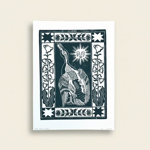 Decorative print with a stylized bird design on a wooden surface