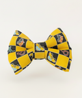 Yellow and black checkered bow tie on a wooden surface