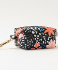 Floral patterned pouch with a keychain on a wooden surface